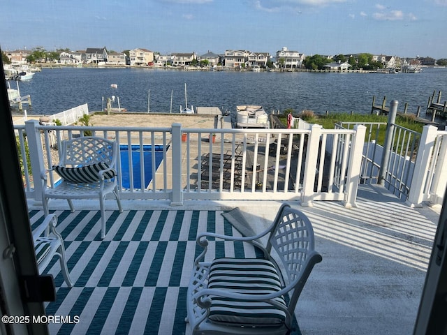 exterior space with a water view and a boat dock