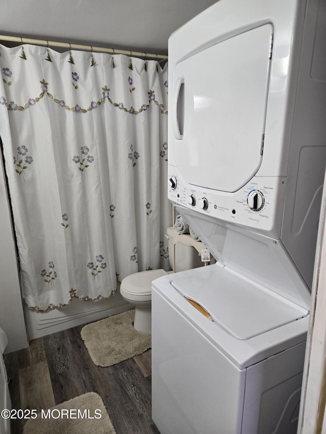 2300 Massachusetts Ave Unit 42, Toms River, NJ 08755 - bathroom with stacked washing maching and dryer, wood-type flooring, toilet, and shower / bath combo with shower curtain