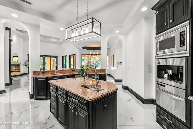 1548 N Bay Ave, Toms River, NJ 08753 - kitchen featuring dark cabinets, light marble finish flooring, recessed lighting, stainless steel appliances, and a warming drawer