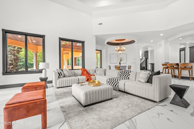 1548 N Bay Ave, Toms River, NJ 08753 - living area featuring arched walkways, marble finish floors, a towering ceiling, recessed lighting, and a chandelier