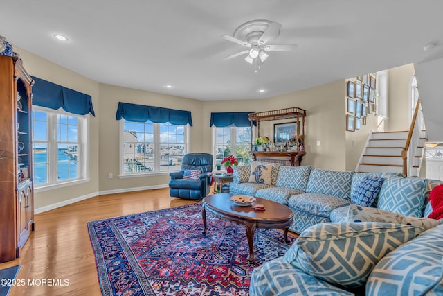 living room with hardwood / wood-style flooring and ceiling fan