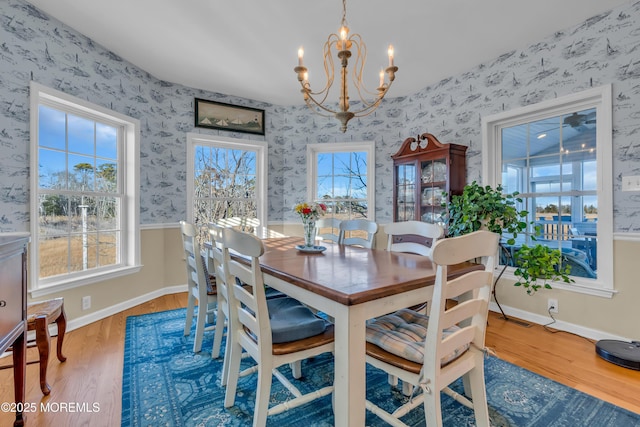 dining room with wood-type flooring and a chandelier