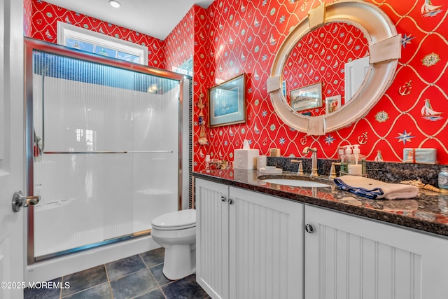 bathroom with vanity, toilet, and walk in shower