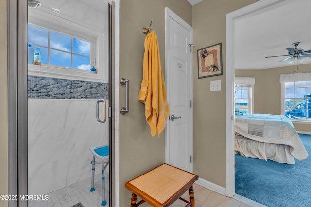 bathroom with a shower with shower door and ceiling fan