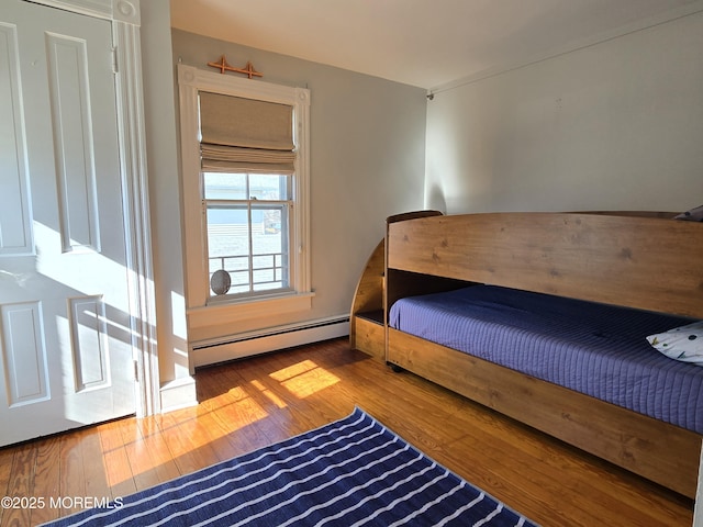 bedroom featuring a baseboard radiator and hardwood / wood-style floors