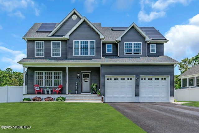 craftsman-style home with a garage, a porch, a front yard, and solar panels