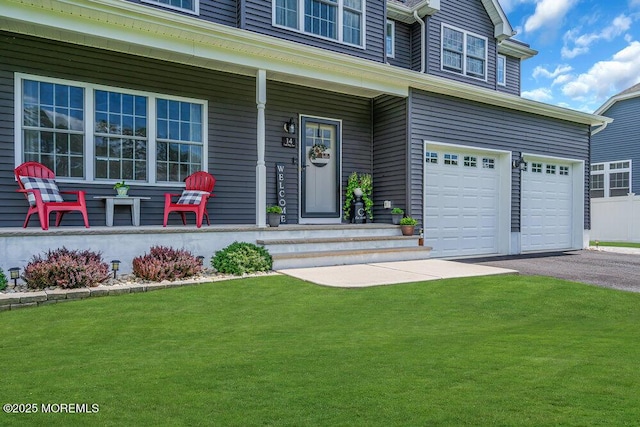 doorway to property with a garage, covered porch, and a lawn