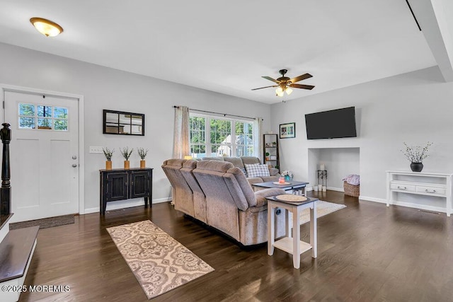 living room with dark wood-type flooring and ceiling fan