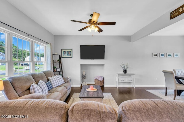 living room with ceiling fan and dark hardwood / wood-style flooring