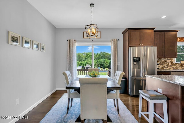 dining room featuring dark hardwood / wood-style floors and a chandelier