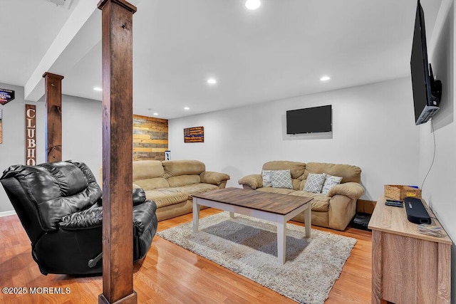 living room featuring ornate columns and light hardwood / wood-style flooring