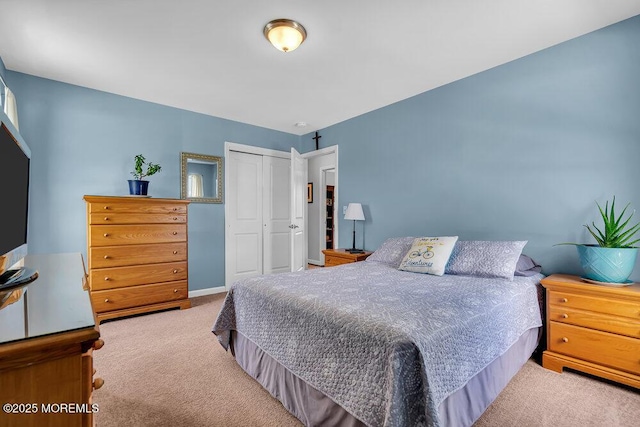 bedroom with light carpet and a closet