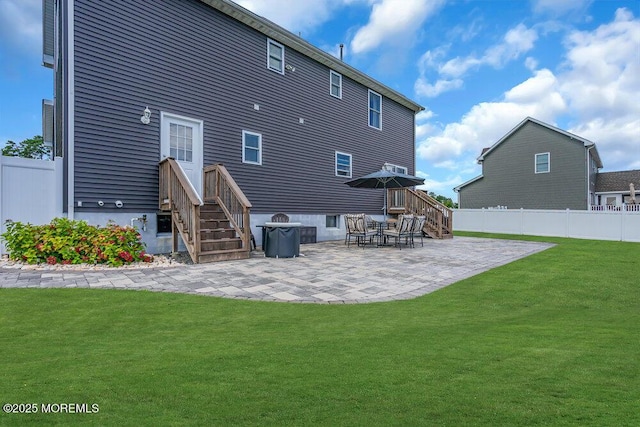 rear view of property featuring a patio and a yard