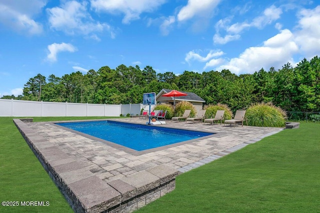 view of pool with a patio area and a lawn