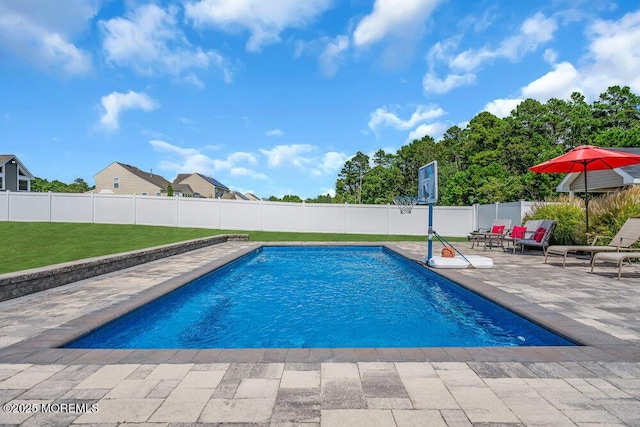 view of pool featuring a yard and a patio area