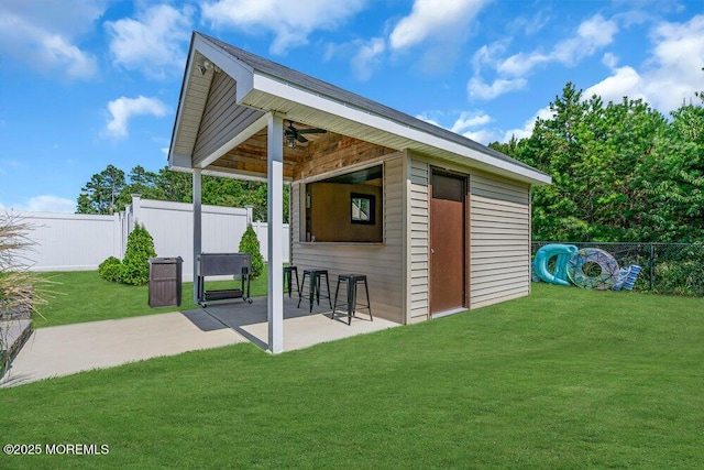 view of outbuilding featuring a lawn