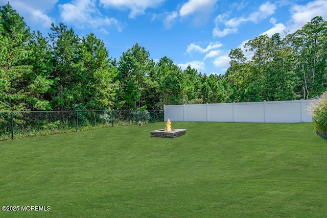 view of yard with an outdoor fire pit