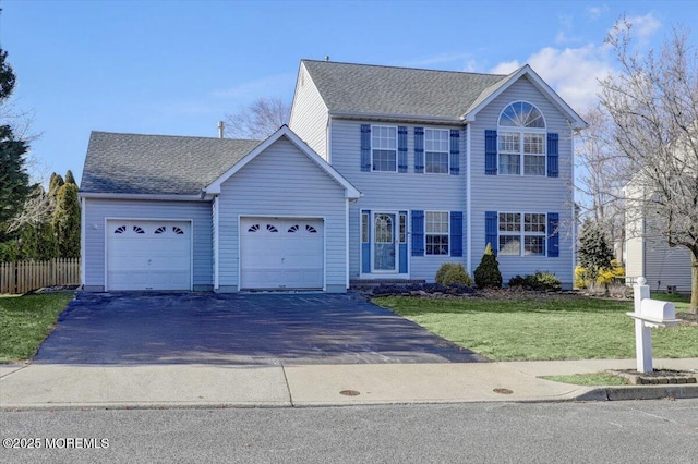 view of front of property featuring a garage and a front lawn