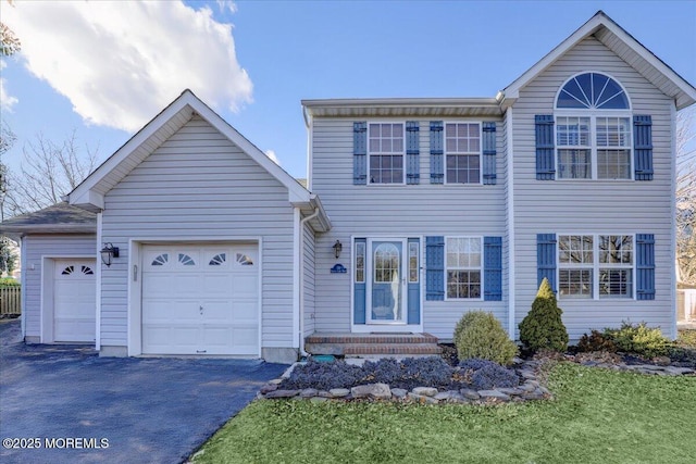 view of front of property with a garage and a front yard