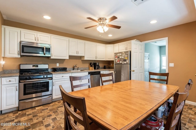 kitchen featuring sink, ceiling fan, white cabinets, and appliances with stainless steel finishes