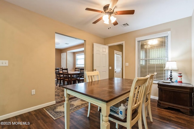 dining room with ceiling fan and dark hardwood / wood-style flooring