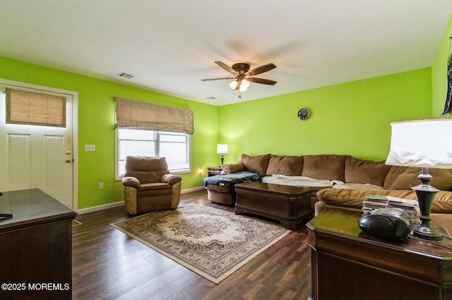 living room with dark wood-type flooring and ceiling fan