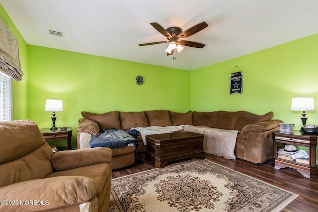 living room with dark hardwood / wood-style floors and ceiling fan