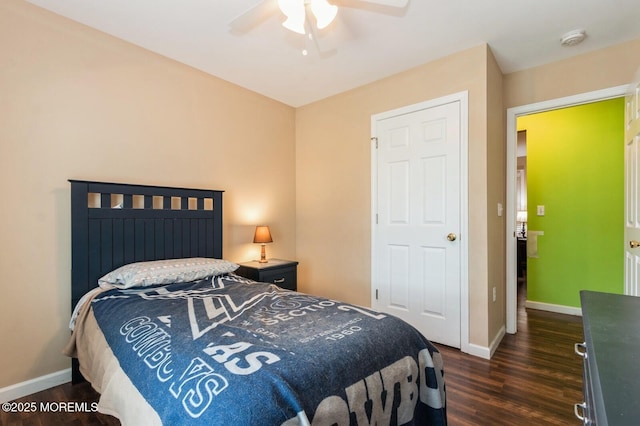 bedroom with dark hardwood / wood-style flooring and ceiling fan