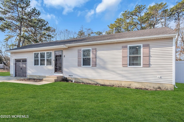 view of front facade with a garage and a front lawn