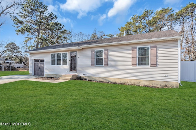 view of front of house featuring a garage and a front lawn