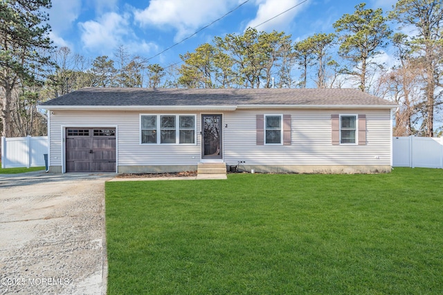 single story home featuring a garage and a front yard