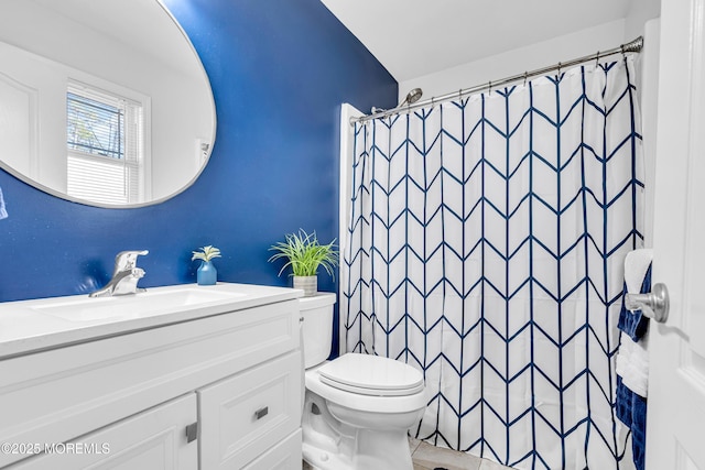 bathroom featuring vanity, curtained shower, and toilet