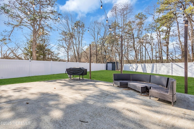 view of patio with an outdoor living space and a storage unit