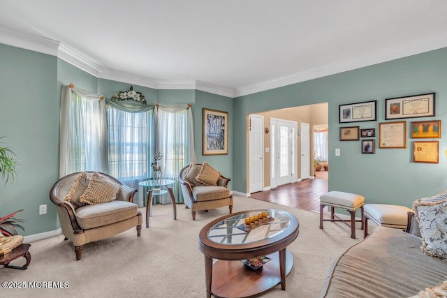 living room with baseboards, ornamental molding, and carpet flooring