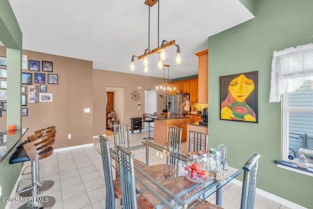 dining room featuring light tile patterned flooring and baseboards