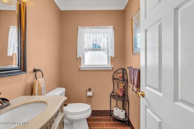 half bath with crown molding, toilet, wood tiled floor, vanity, and baseboards