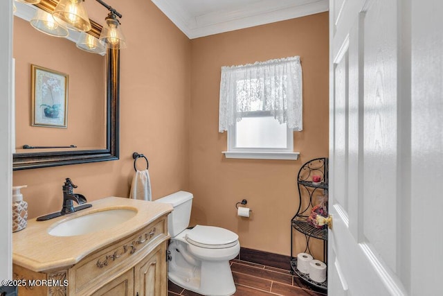 half bath featuring toilet, vanity, baseboards, ornamental molding, and wood tiled floor