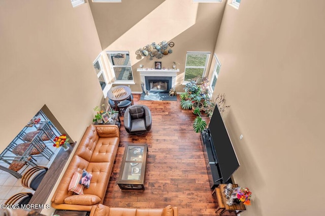 living room with a high ceiling and a fireplace