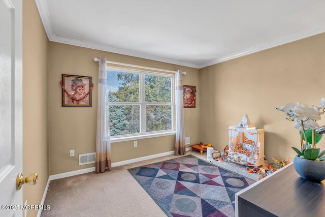 recreation room with carpet floors, ornamental molding, visible vents, and baseboards