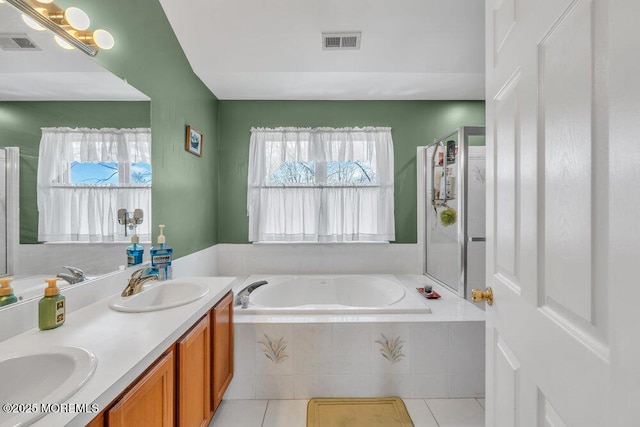 full bathroom with tile patterned flooring, visible vents, and a sink