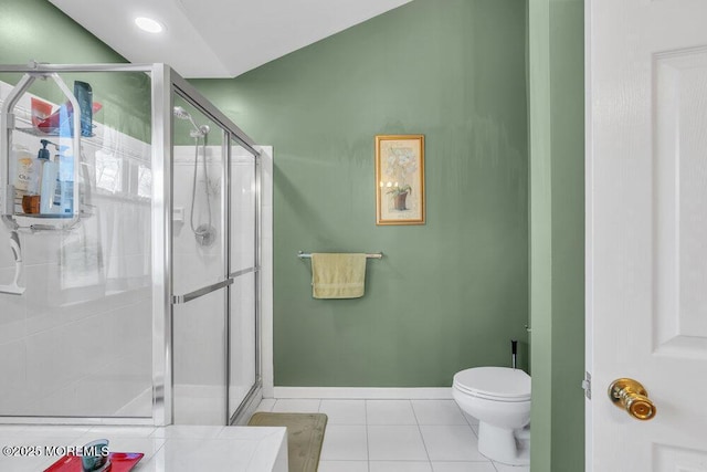 full bath featuring baseboards, a stall shower, toilet, and tile patterned floors