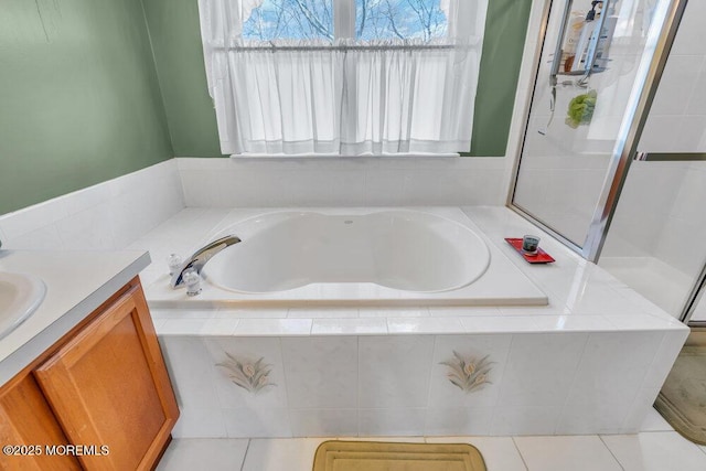 bathroom featuring a bath, vanity, a shower stall, and tile patterned floors