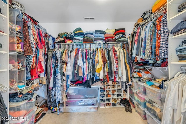 walk in closet with visible vents and carpet flooring