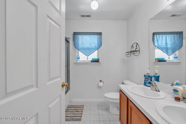 full bathroom featuring visible vents, toilet, tile patterned floors, combined bath / shower with glass door, and a sink