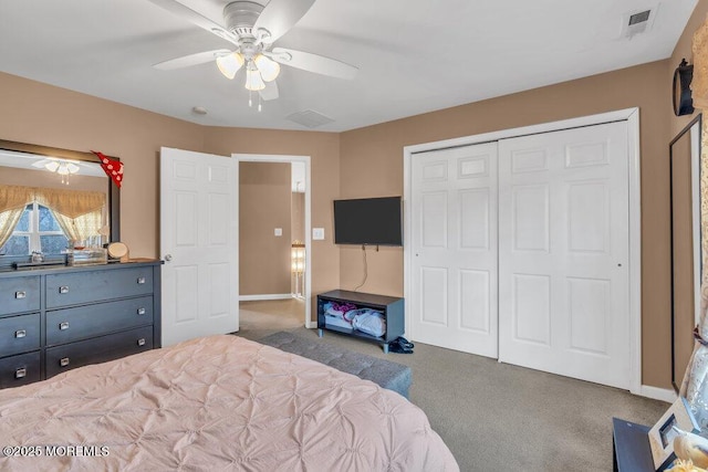 bedroom with baseboards, visible vents, ceiling fan, dark carpet, and a closet