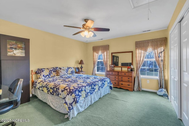 carpeted bedroom featuring attic access, visible vents, ceiling fan, and baseboards