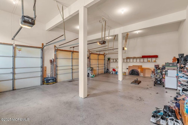 garage with freestanding refrigerator and a garage door opener