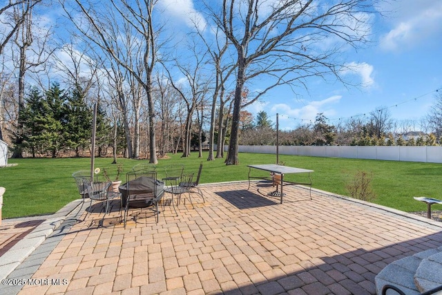 view of patio featuring an outdoor fire pit and fence