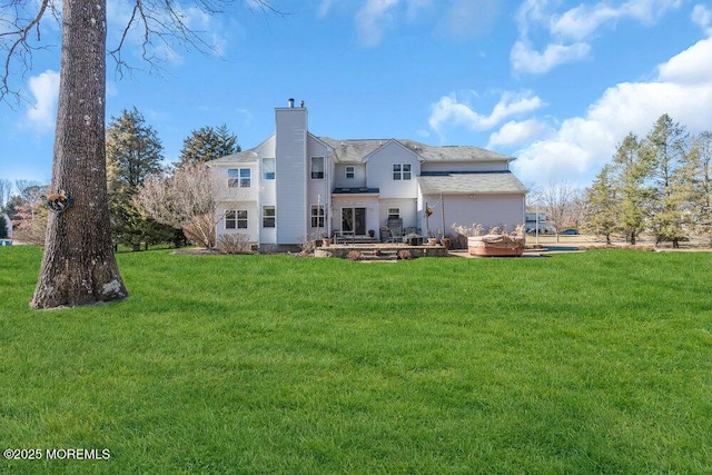 back of house with a yard and a chimney