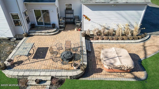 view of property exterior featuring a shingled roof and a patio area